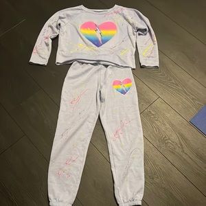 Purple sweatsuit with heart and paint splatter.